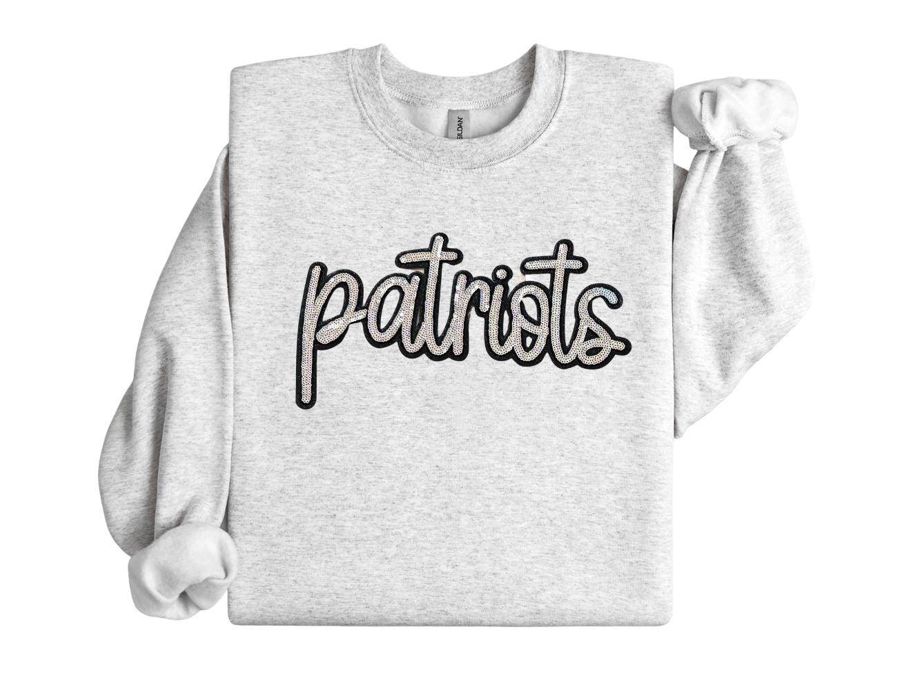 Gray sweatshirt with 'patriots' text on a white background