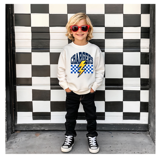 Child wearing a 'Chargers' sweatshirt with a checkered design in front of a black and white checkered wall.