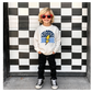 Child wearing a 'Chargers' sweatshirt with a checkered design in front of a black and white checkered wall.