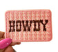 May include: A pink embroidered patch with the word &#39;HOWDY&#39; in brown thread.