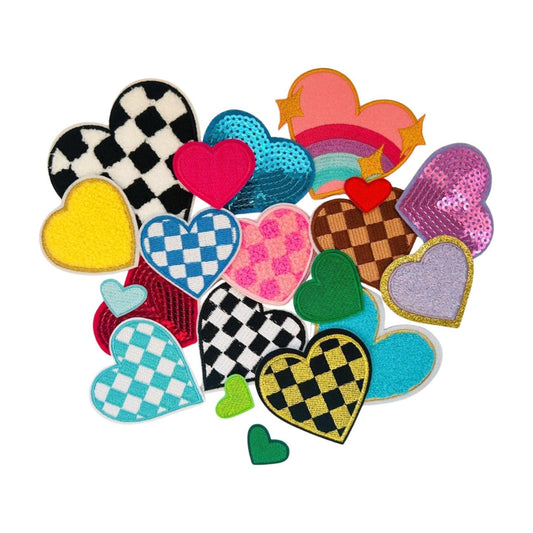 May include: A collection of colorful heart-shaped patches with various designs, including checkered, sequined, and fuzzy textures. The patches are arranged in a loose, overlapping pattern, creating a visually appealing and playful composition.