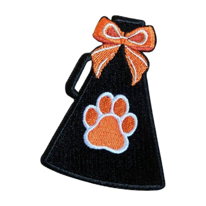 black megaphone with orange paw print and orange bow