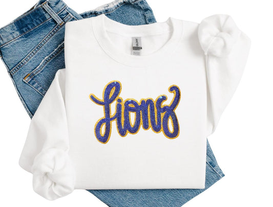 White sweatshirt with 'Lions' text on blue jeans